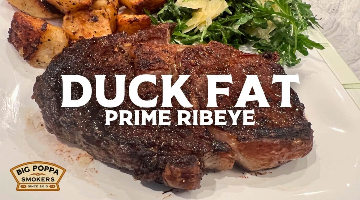 Duck fat-seared prime ribeye served with crispy roasted potatoes and a fresh arugula salad.