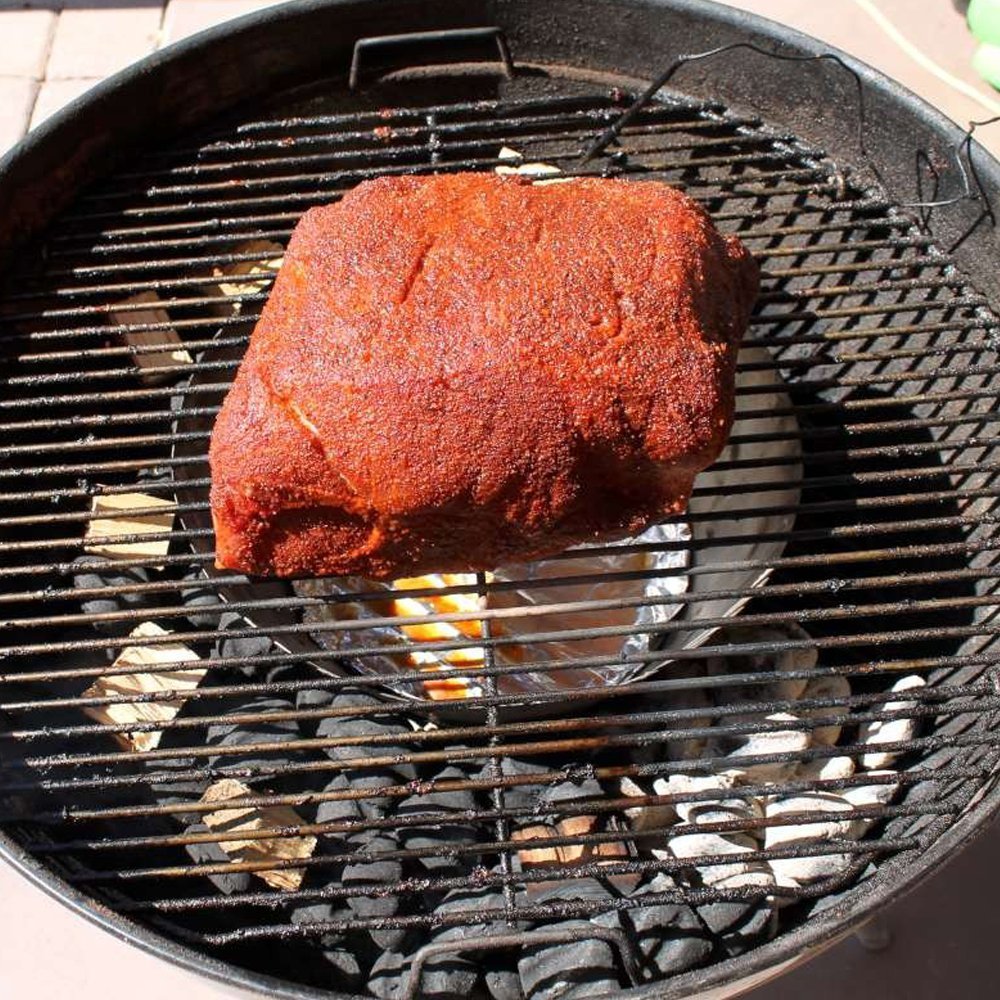 Close-up of the perforated stainless steel vortex insert with textured surface and engraved "BBQ Vortex" logo for medium