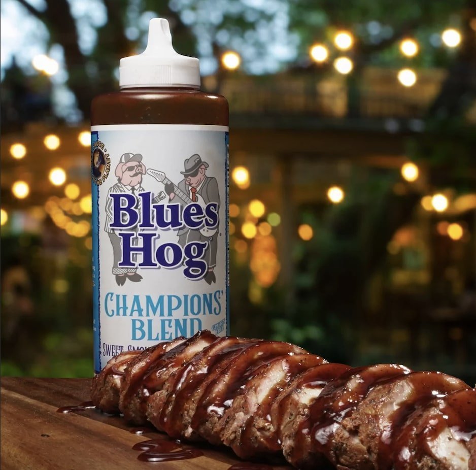 Close-up of the Blues Hog Champions’ Blend BBQ Sauce squeeze bottle tip, highlighting the textured nozzle and vibrant label