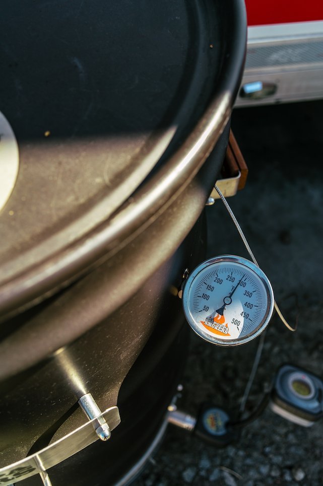 Close-up of the BPS Carbon Drum Smoker's textured black surface with visible ventilation holes and chrome handle detail
