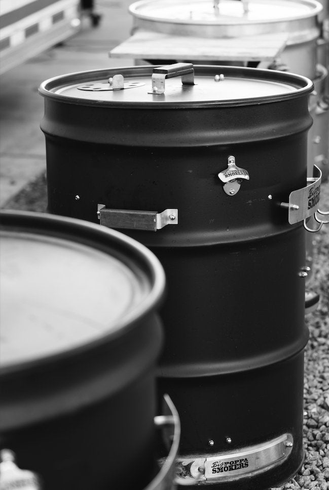 Close-up of the BPS Carbon Drum Smoker kit’s pre-drilled aluminum lid with textured surface and visible air vent opening.