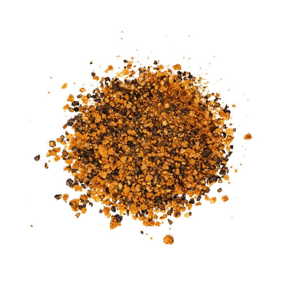 Close-up of the hand-crafted spice blend texture on the Chicken Fried BBQ Texas Rib Grind rub in 11oz jar highlighting
