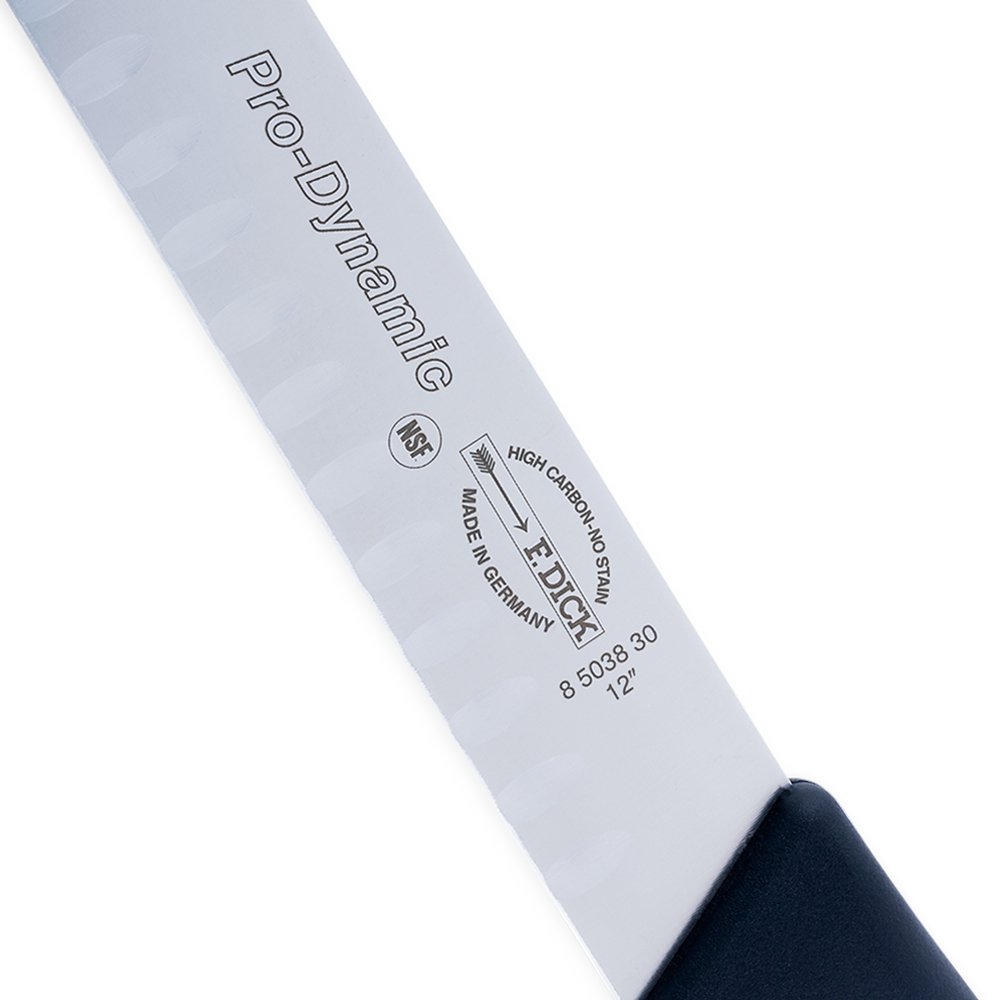 Close-up of the 12-inch hollow ground blade’s textured edge and polished finish from a slight diagonal angle.