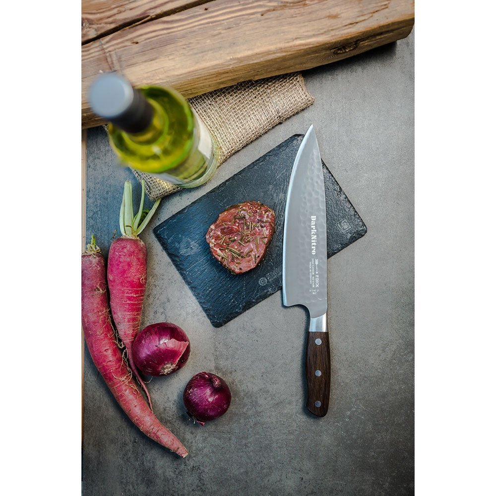 Close-up of the F. Dick DarkNitro chef's knife handle showing textured black grip and engraved logo on stainless steel