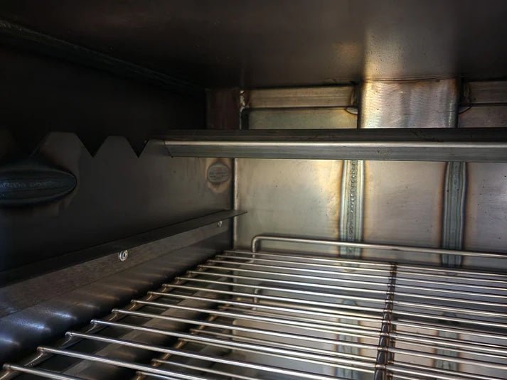 Close-up of the Qube'd Box lid’s textured surface and engraved logo showing precise machining details