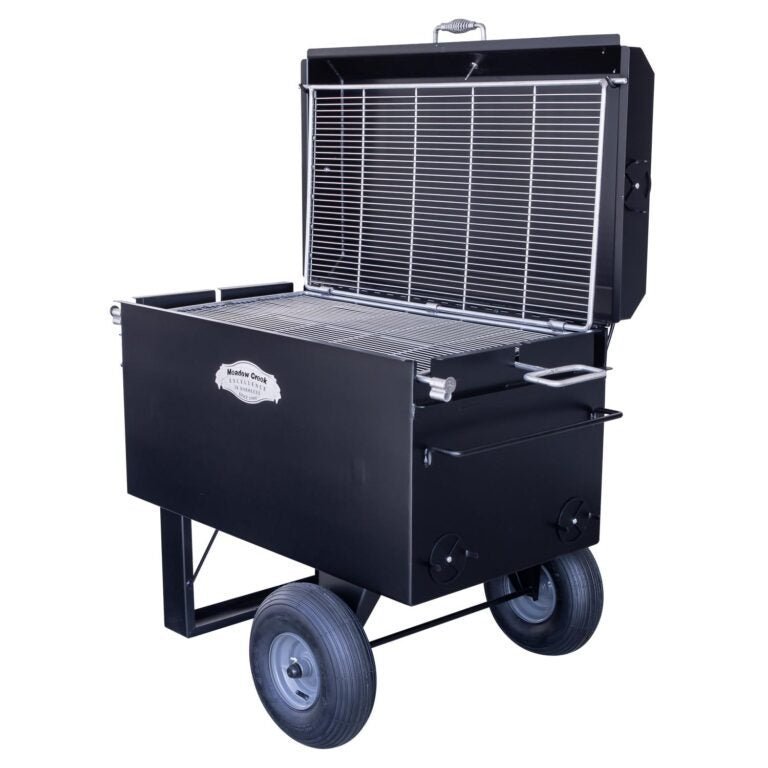 Close-up of the Meadow Creek BBQ42 Chicken Cooker’s stainless steel lid handle and textured surface detail from an overhead