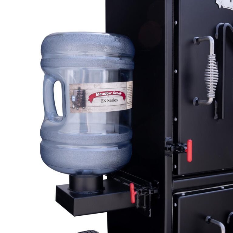 Close-up of the BX25 smoker’s stainless steel lid vent with adjustable slide and engraved logo detail.