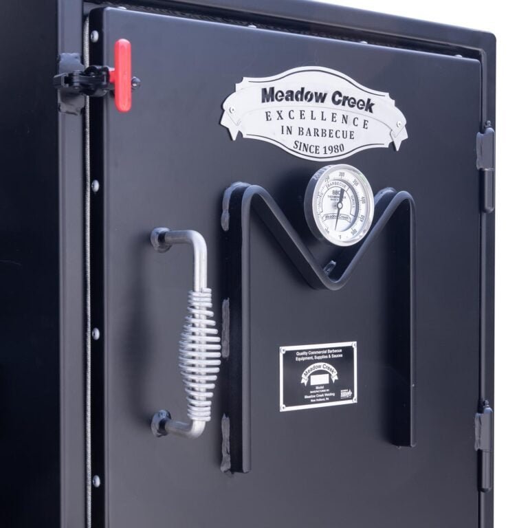 Close-up of the Meadow Creek BX25 cabinet smoker’s stainless steel latching door with black handle and vent details