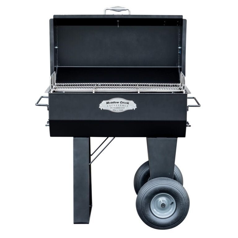 Close-up of the Meadow Creek PR36 Pig Roaster's adjustable front-mounted cooking grate with textured metal surface and