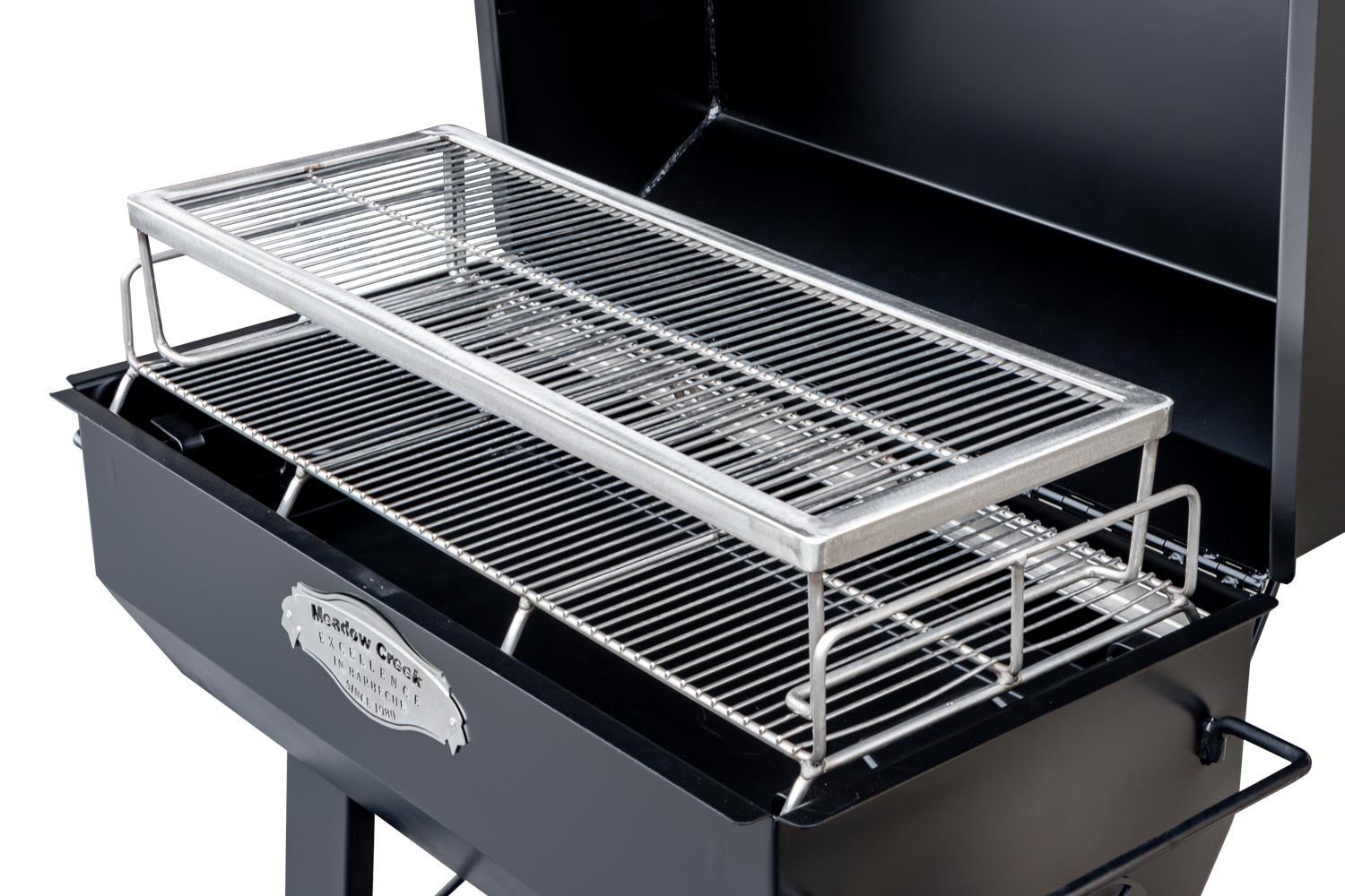 Close-up of the polished stainless steel lid latch and textured handle on the Meadow Creek PR42 Pig Roaster, highlighting