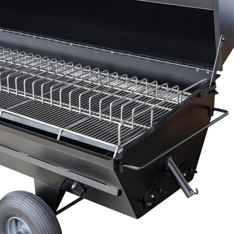 Close-up of the polished stainless steel grill grate with textured surface and embedded branding on the Meadow Creek PR42
