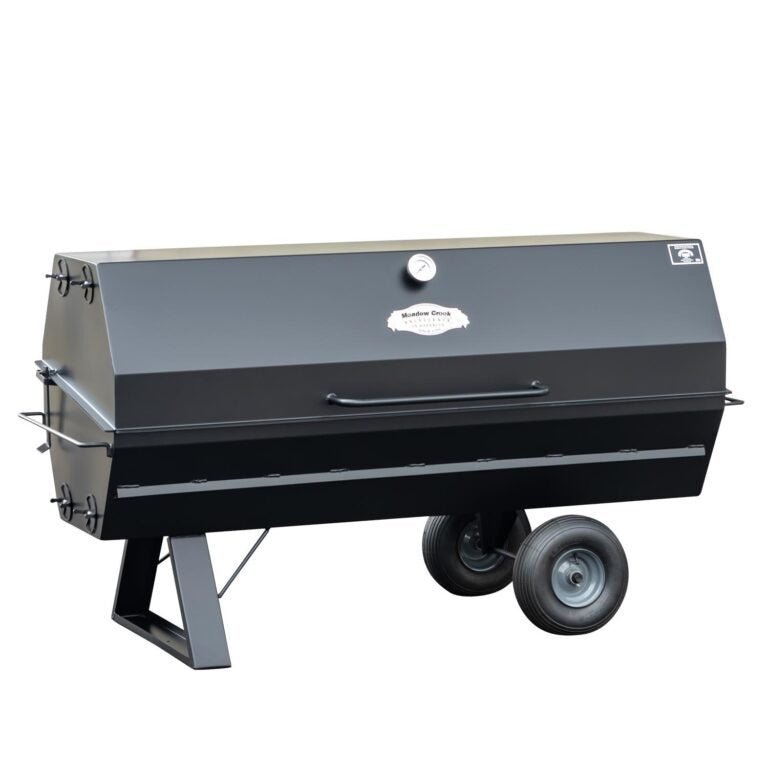 Meadow Creek PR72 pig roaster with black welded steel body, chrome cooking grate, and adjustable charcoal tray