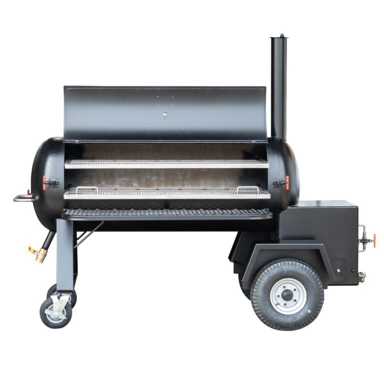 Close-up of temperature gauge with clear black dial, white markings, and red needle on the black smoker lid surface.
