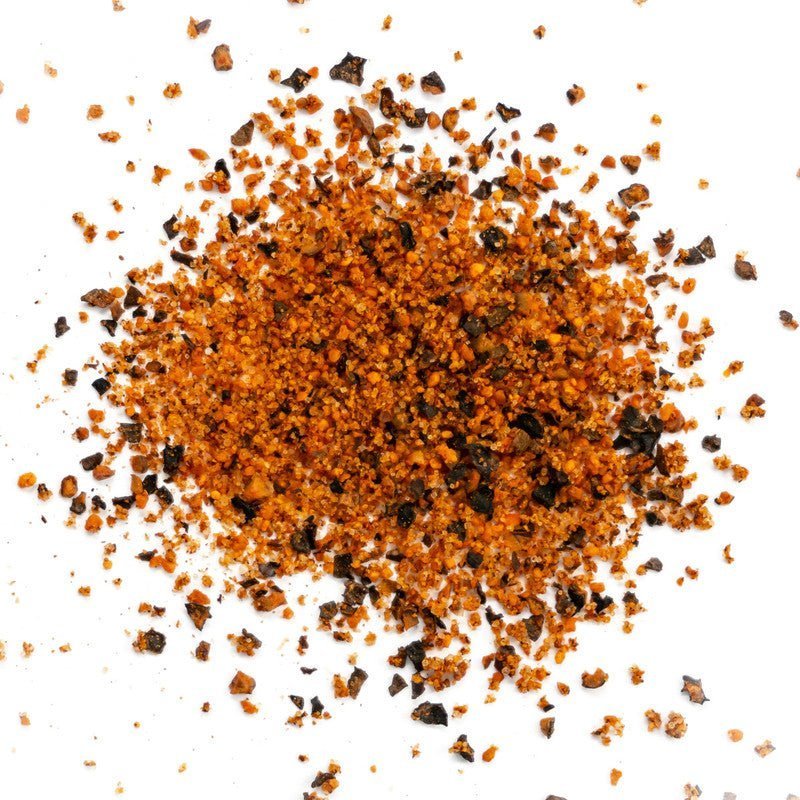 Close-up of the Simply Marvelous BBQ Peppered Cow Rub 5lb bag's textured surface highlighting coarse pepper and herbal