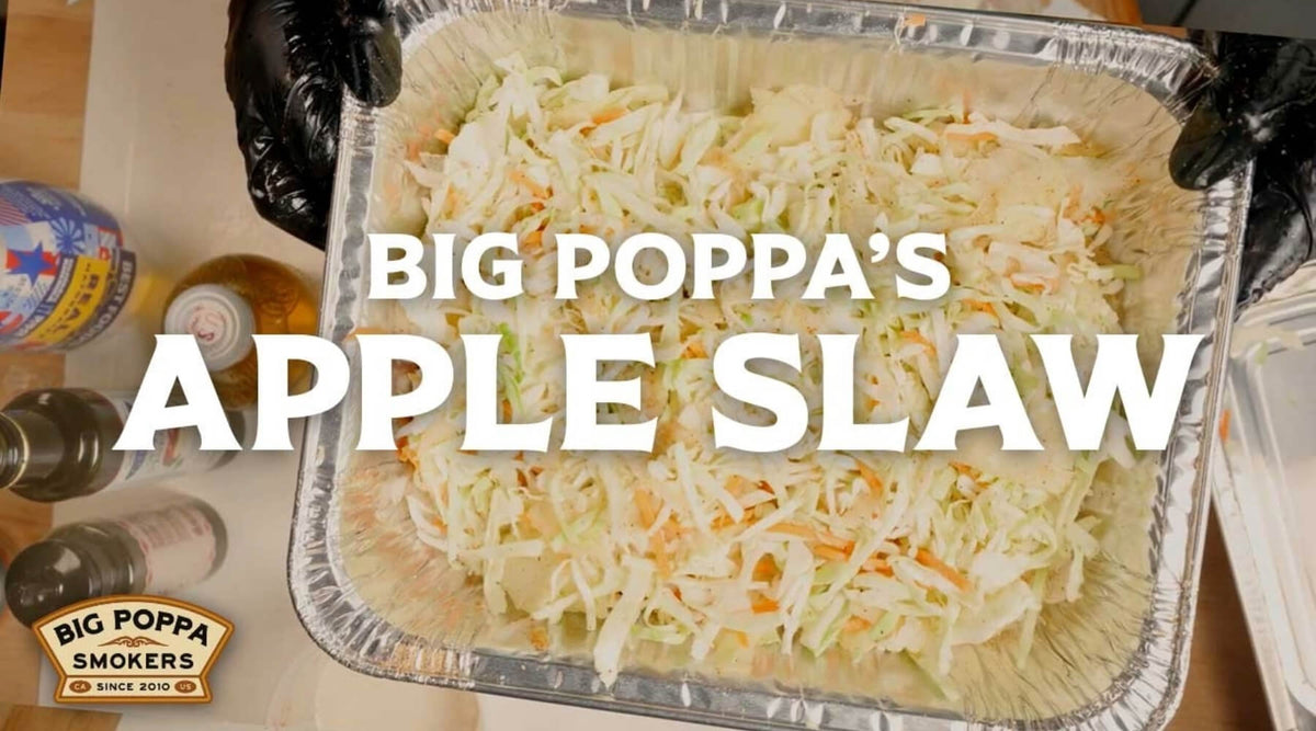 Big Poppa's apple slaw in a foil pan, topped with text reading “Big Poppa's Apple Slaw.”