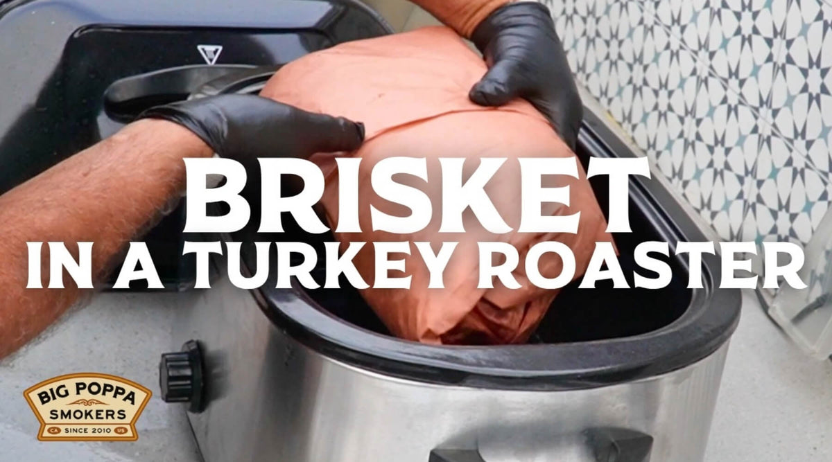 Wrapped brisket being placed into a turkey roaster for an overnight smoked brisket resting method.