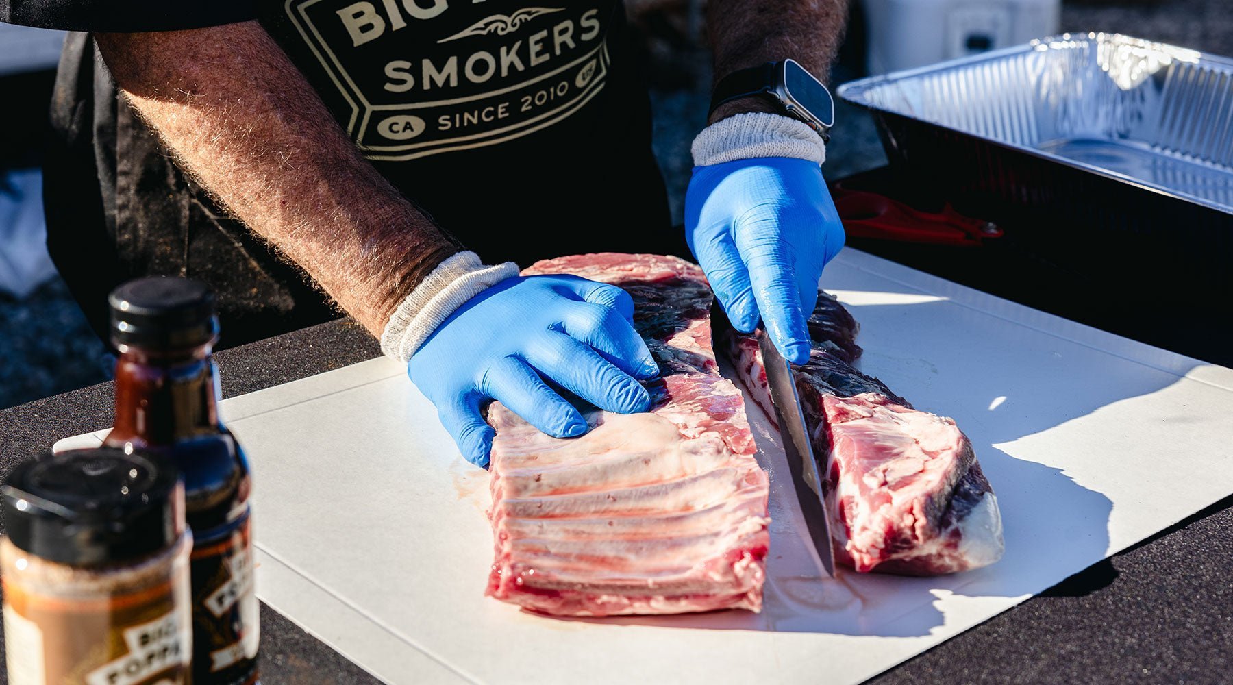 Big Poppa trimming the ribs before seasoning.