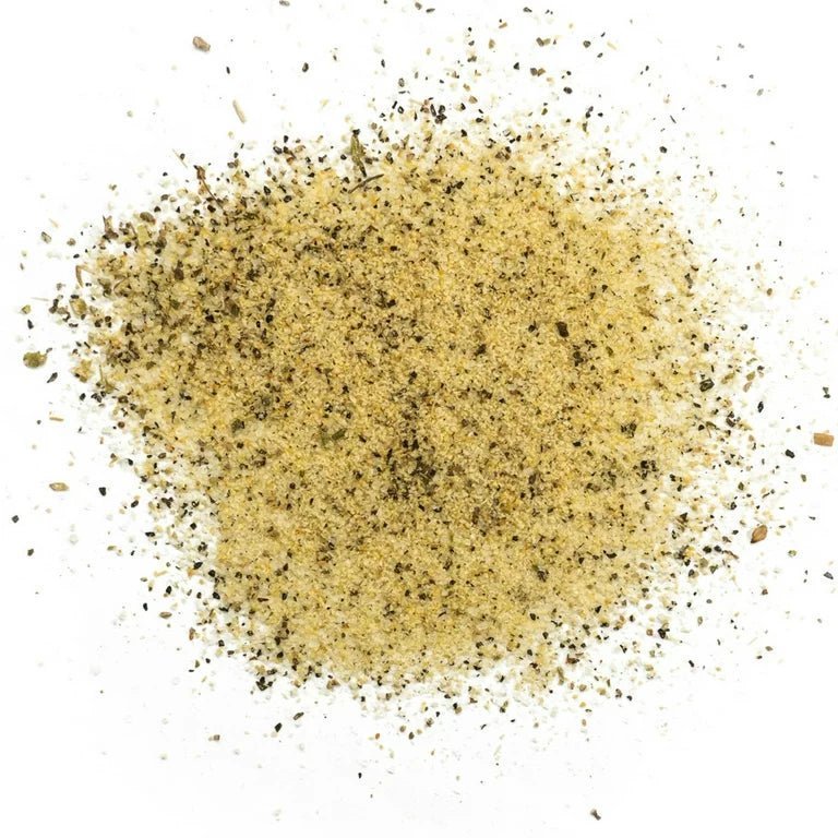 Close-up of the creamy white garlic butter with visible herbs and flecks of seasoning, showcasing its rich, hand-crafted