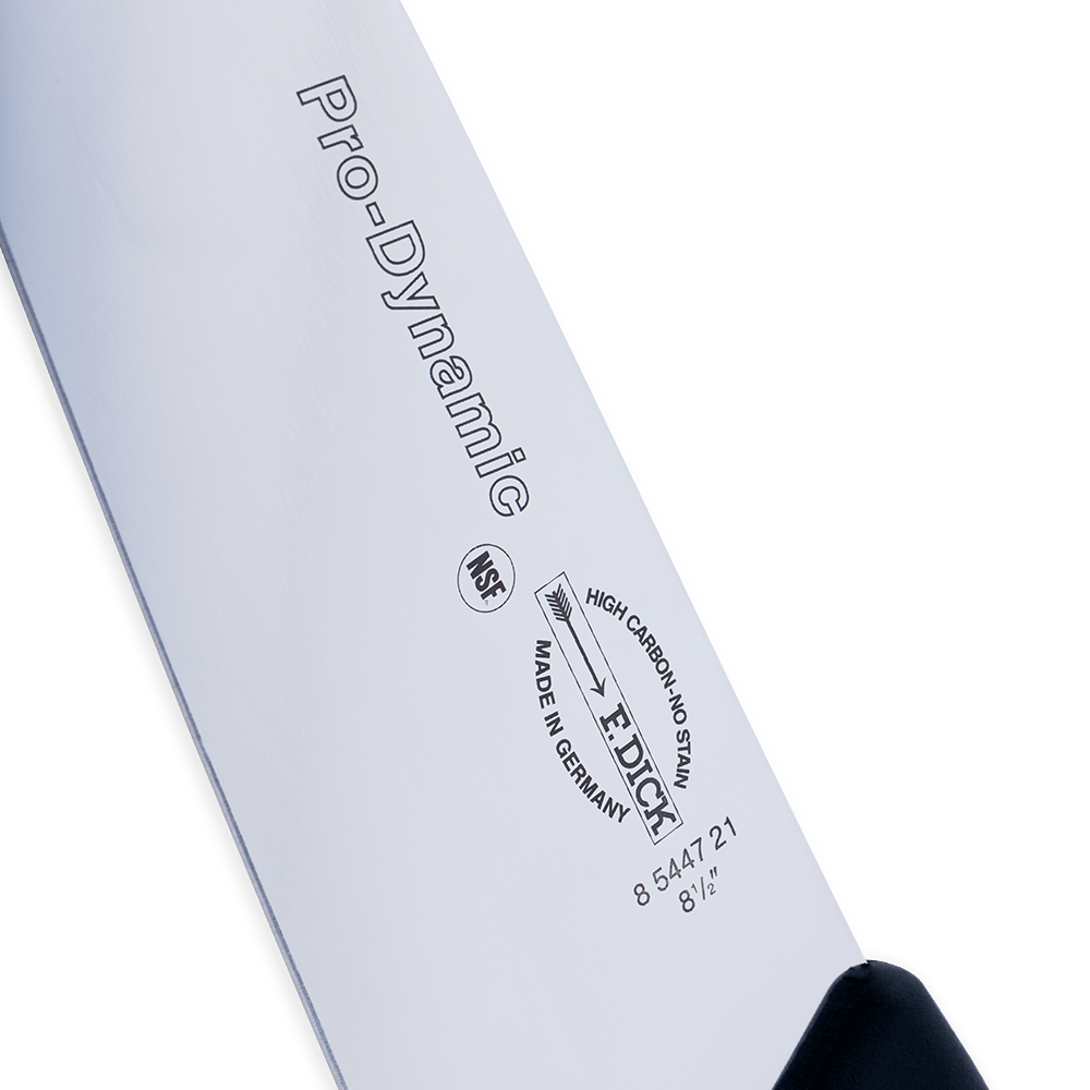 Close-up of the F. Dick 8.5" ProDynamic chef knife’s textured wooden handle and stainless steel bolster at the heel.