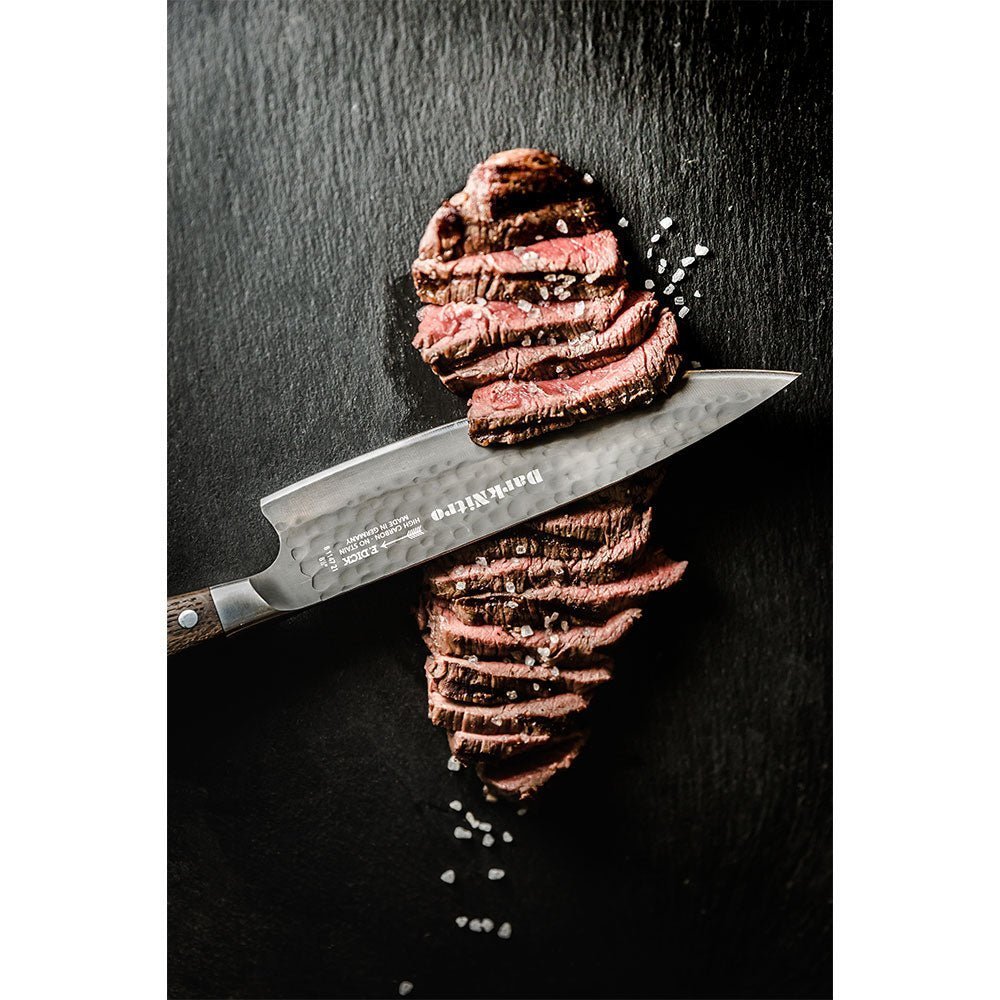 Close-up of the F. Dick DarkNitro chef's knife blade tip revealing textured dark coating and precise edge detail from an