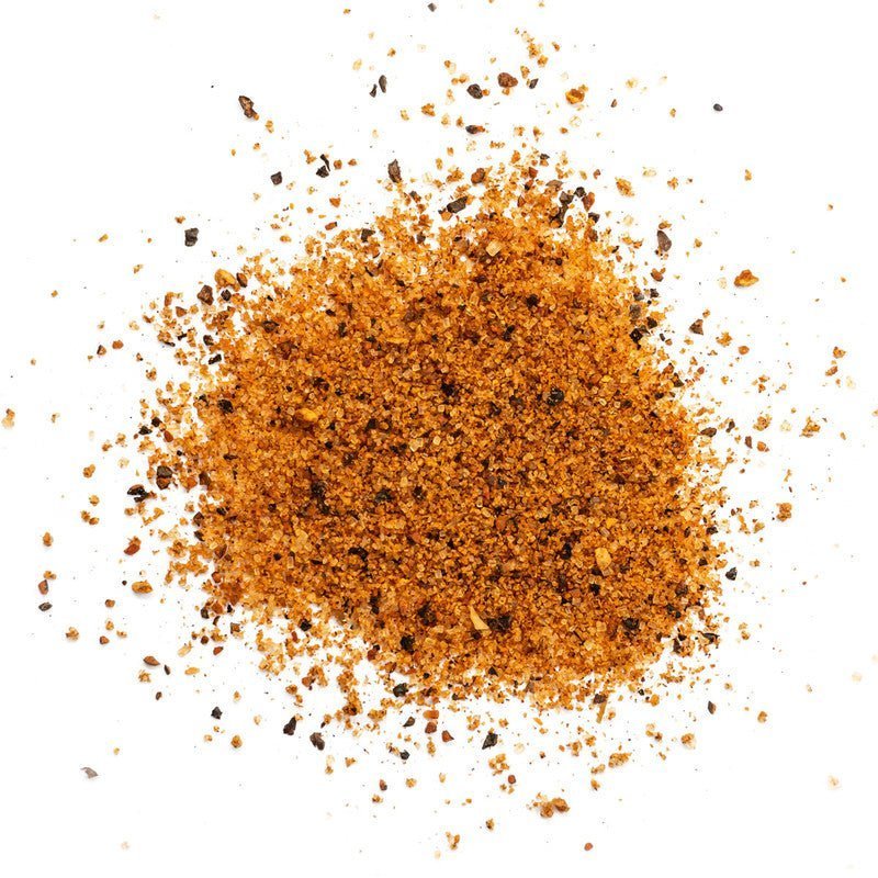 Close-up of the Heavy Smoke Black Label Rub's textured, hand-crafted spice blend with visible dark peppercorns and smoked