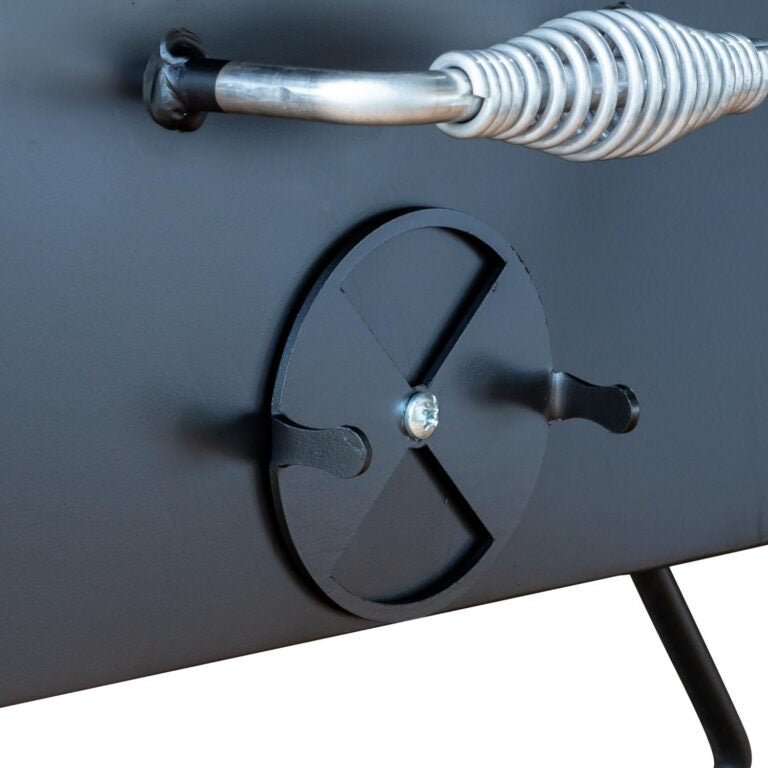 Close-up of the Meadow Creek BBQ18 Chicken Cooker's stainless steel lid handle and textured surface from a top-angle