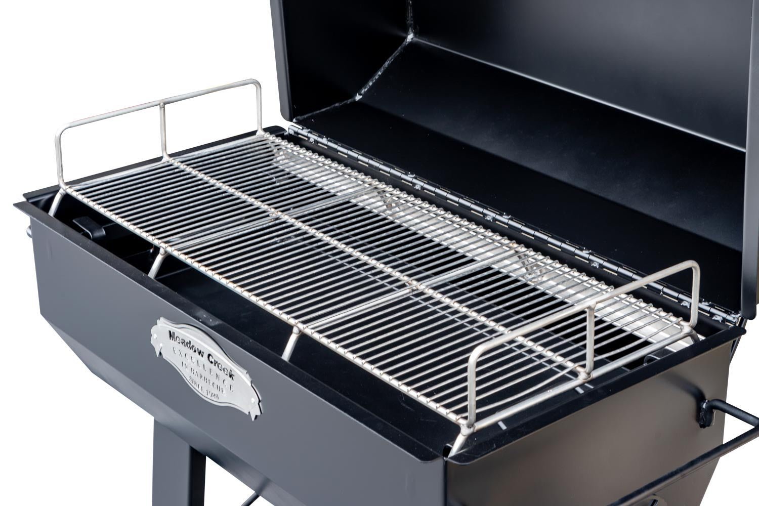 Close-up of the heavy-duty stainless steel cooking grate with textured surface and engraved logo on the Meadow Creek PR36