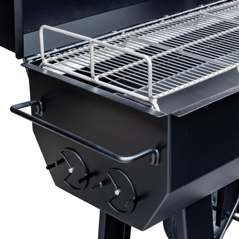Close-up of the heavy-duty stainless steel cooking grate with engraved logo on Meadow Creek PR36 pig roaster barrel