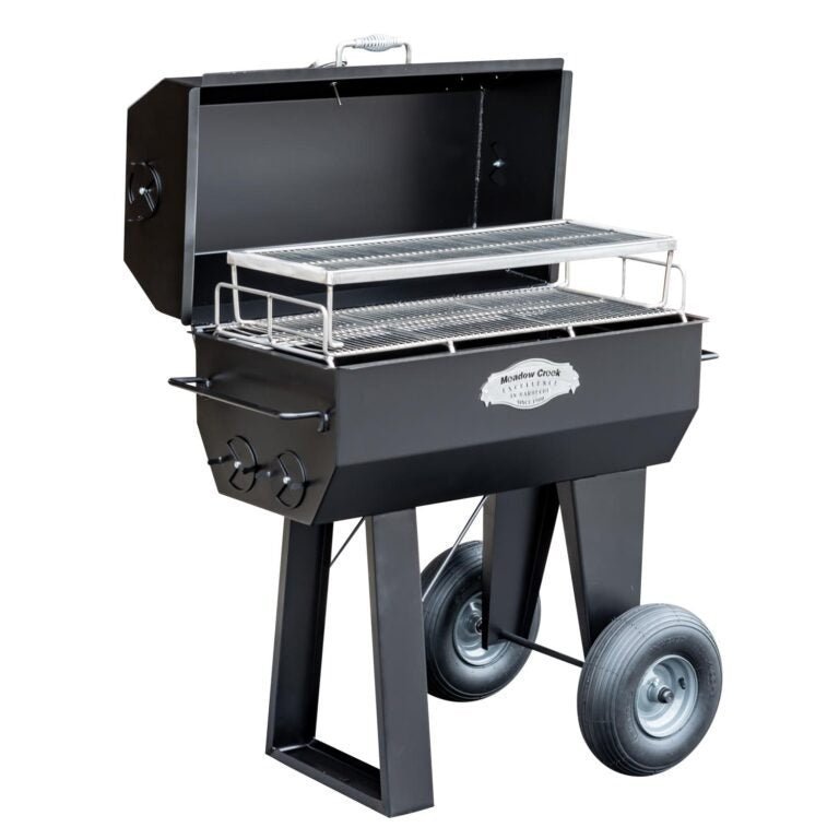 Close-up of the heavy-duty stainless steel cooking grate with textured surface and integrated drip tray for easy cleaning.