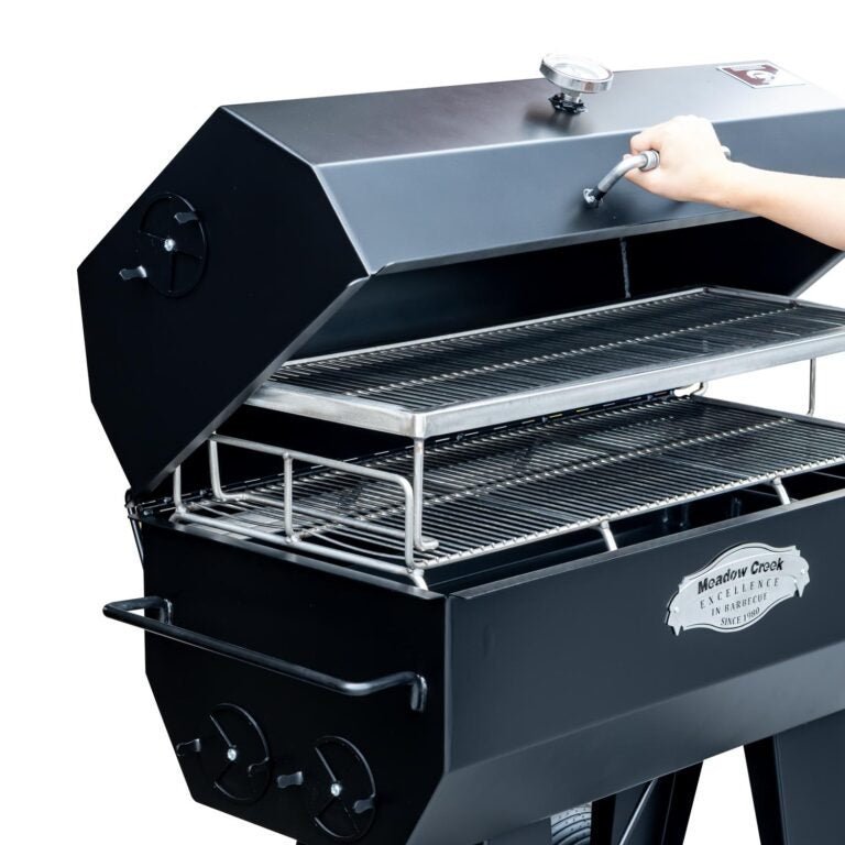Close-up of the black cast iron lid handle and textured surface of Meadow Creek PR36 Pig Roaster highlighting durable