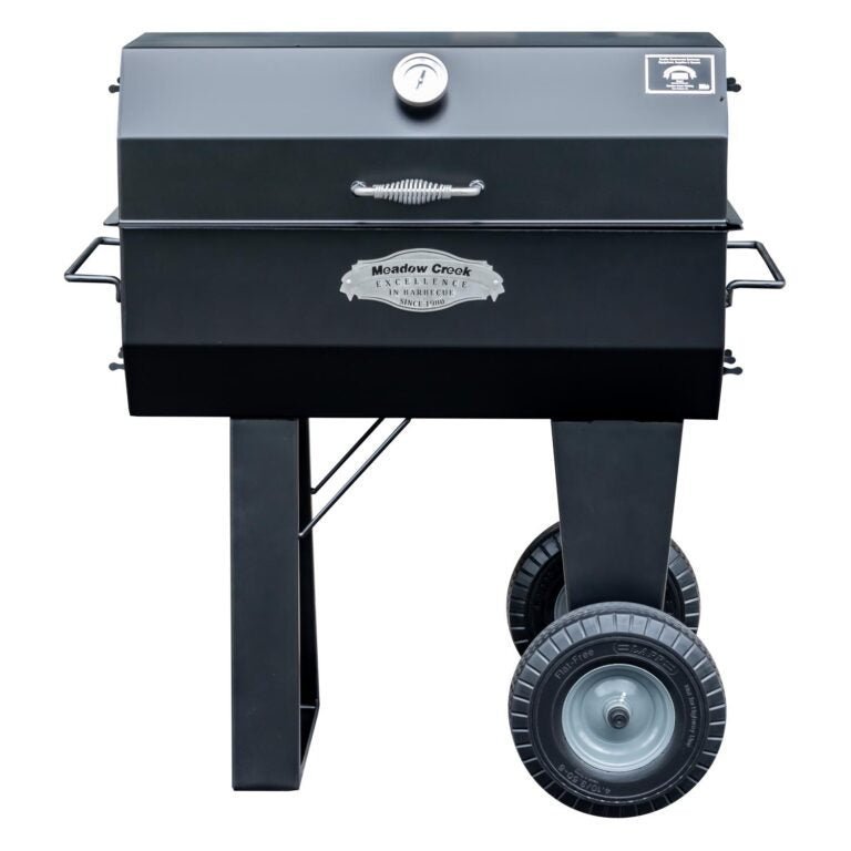 Meadow Creek PR36 pig roaster with black painted steel body, large drum, and adjustable cooking grate in outdoor setting