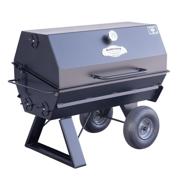 Close-up of the matte black temperature gauge and stainless steel lid handle on the Meadow Creek PR42 Pig Roaster