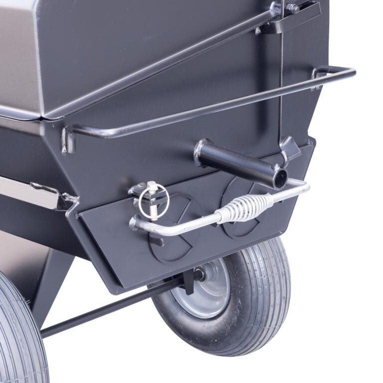 Close-up of the sturdy stainless steel lid latch and textured surface of the Meadow Creek PR42 Pig Roaster from a slightly