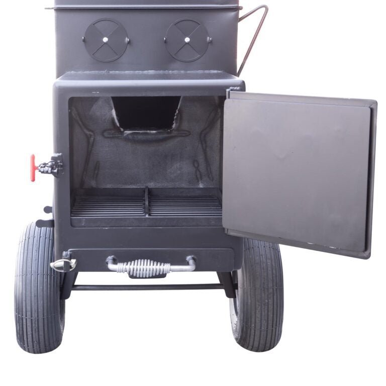 Close-up of the black steel smoke chamber latch and handle with textured grip on the Meadow Creek SQ36 offset smoker