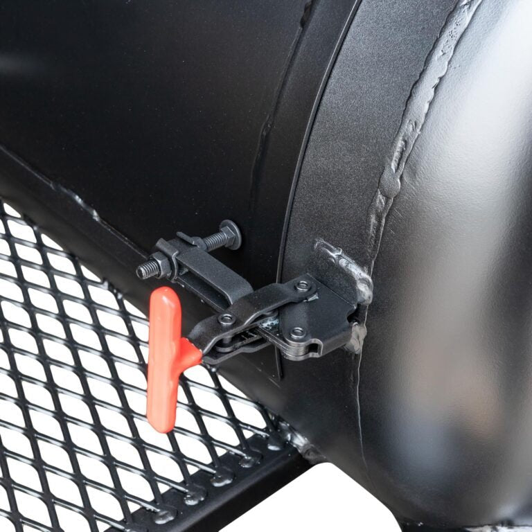 Close-up of the black steel lid latch and textured surface of the Meadow Creek TS120P offset smoker from a slight overhead