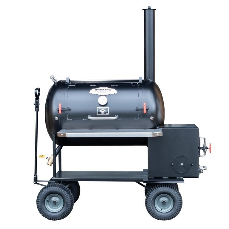 Close-up of the black steel fire box with textured surface and chrome temperature gauge on the Meadow Creek TS70P smoker