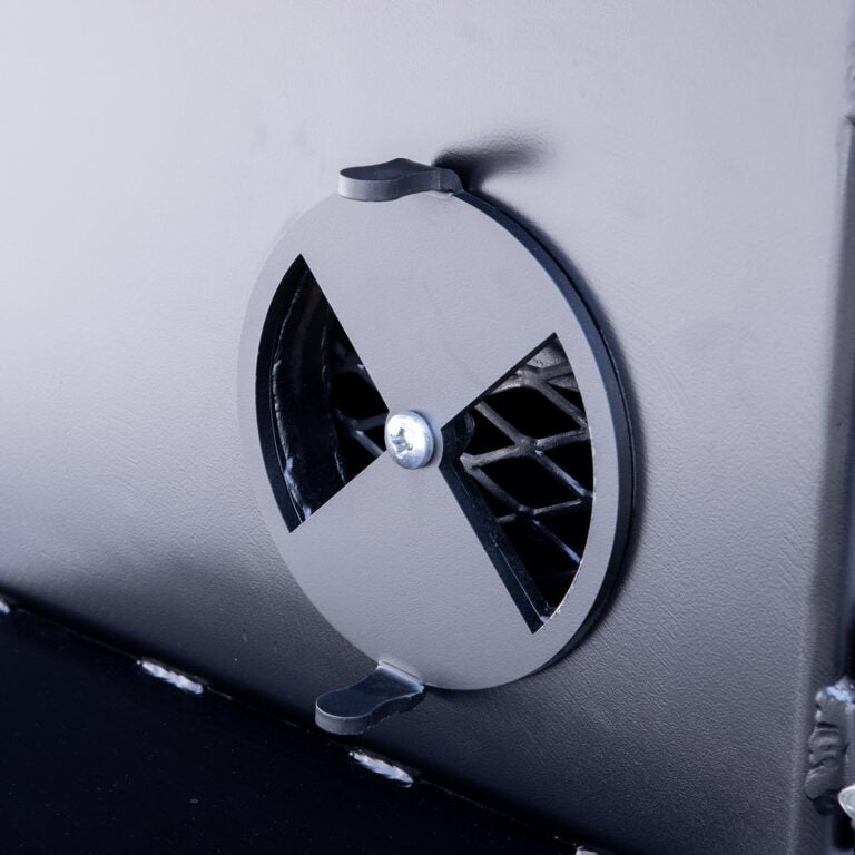 Close-up of the black steel temperature gauge on the top lid of the Meadow Creek TS70P Offset BBQ Smoker, showcasing clear