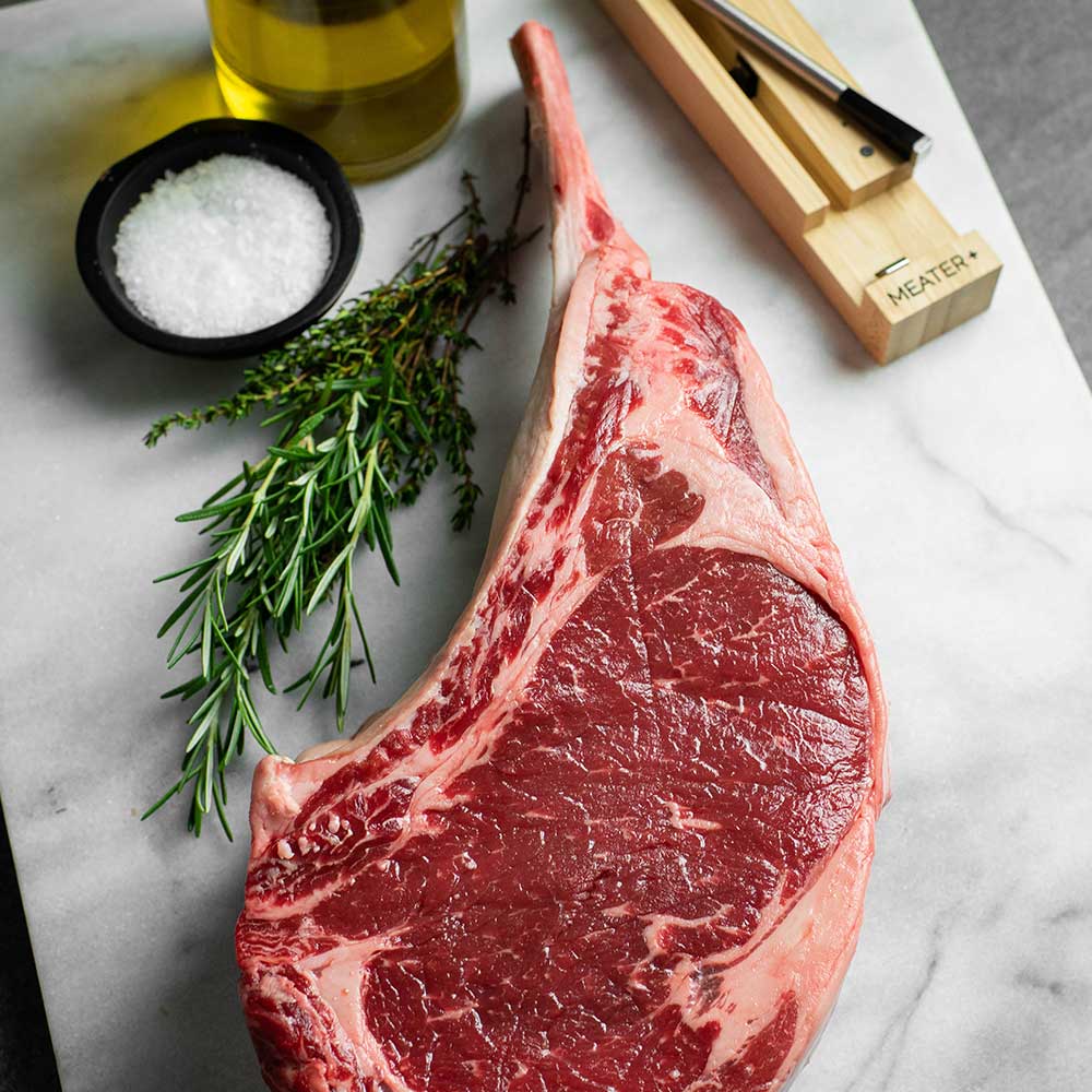Close-up of MEATER Plus wireless meat probe attached to a cooked grass-fed steak, highlighting the temperature sensor and